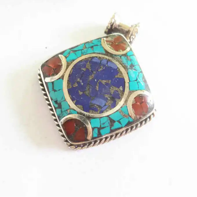 Nepalese charm on white Indian copper